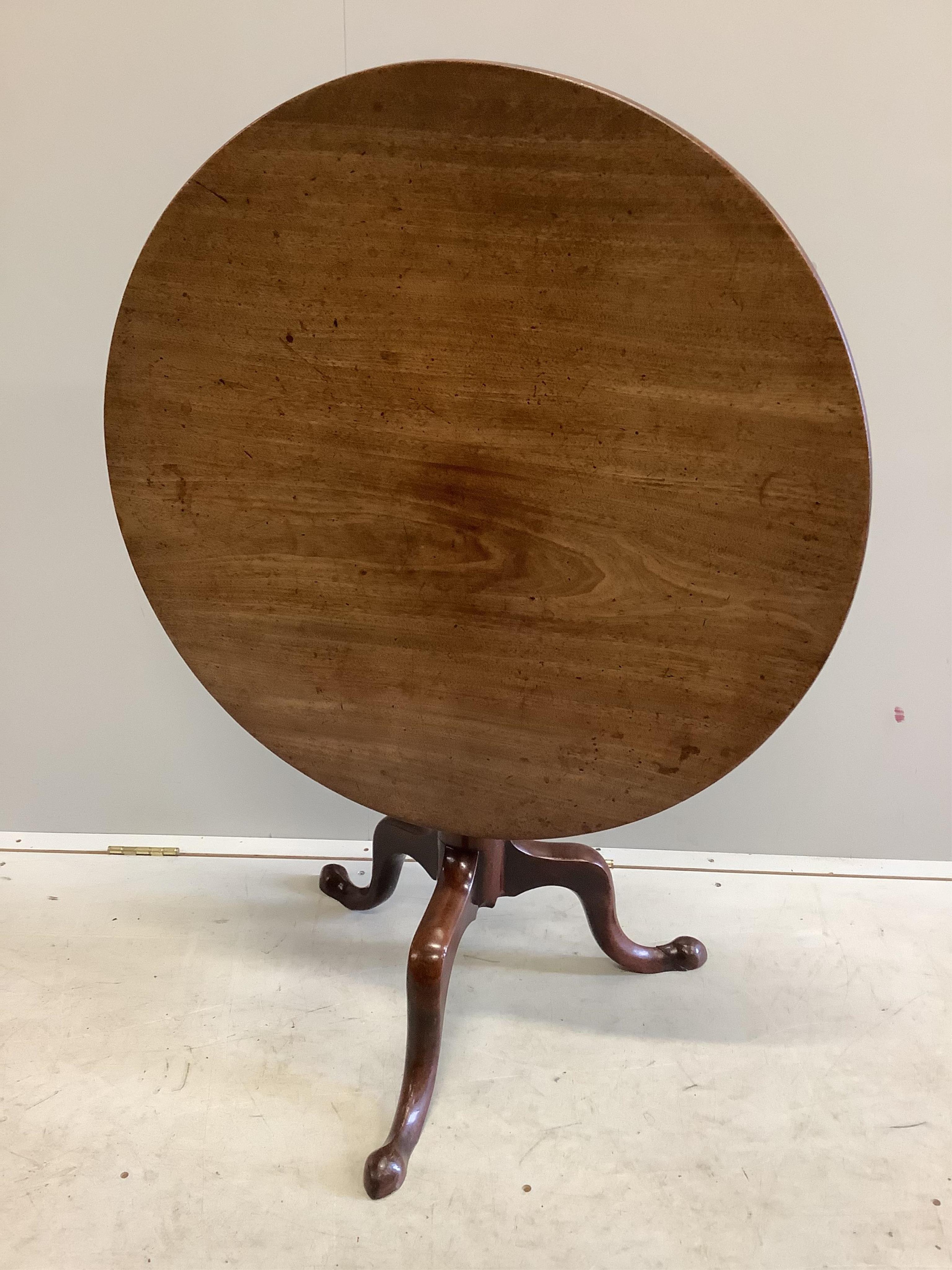 A George III circular mahogany tilt top tripod tea table, diameter 79cm, height 70cm. Condition - fair to good